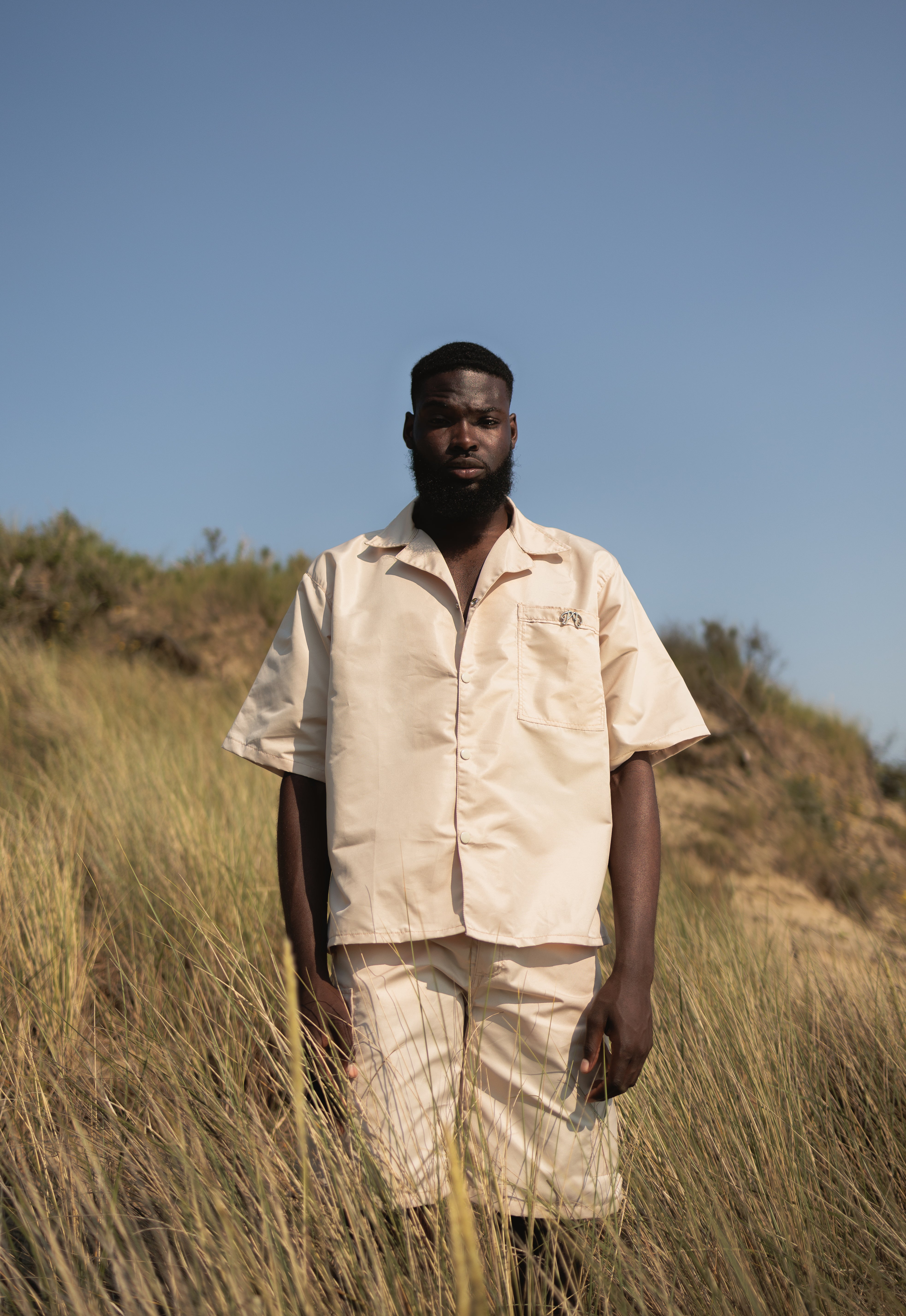 Picou Beige/cream Nylon Short offers a loose fit and feature two large side pockets and belt loops with a metal logo. The shorts come with a slightly pleated front and boast a trendy, luxury design, making them perfect for a special occasion or relaxed wear.