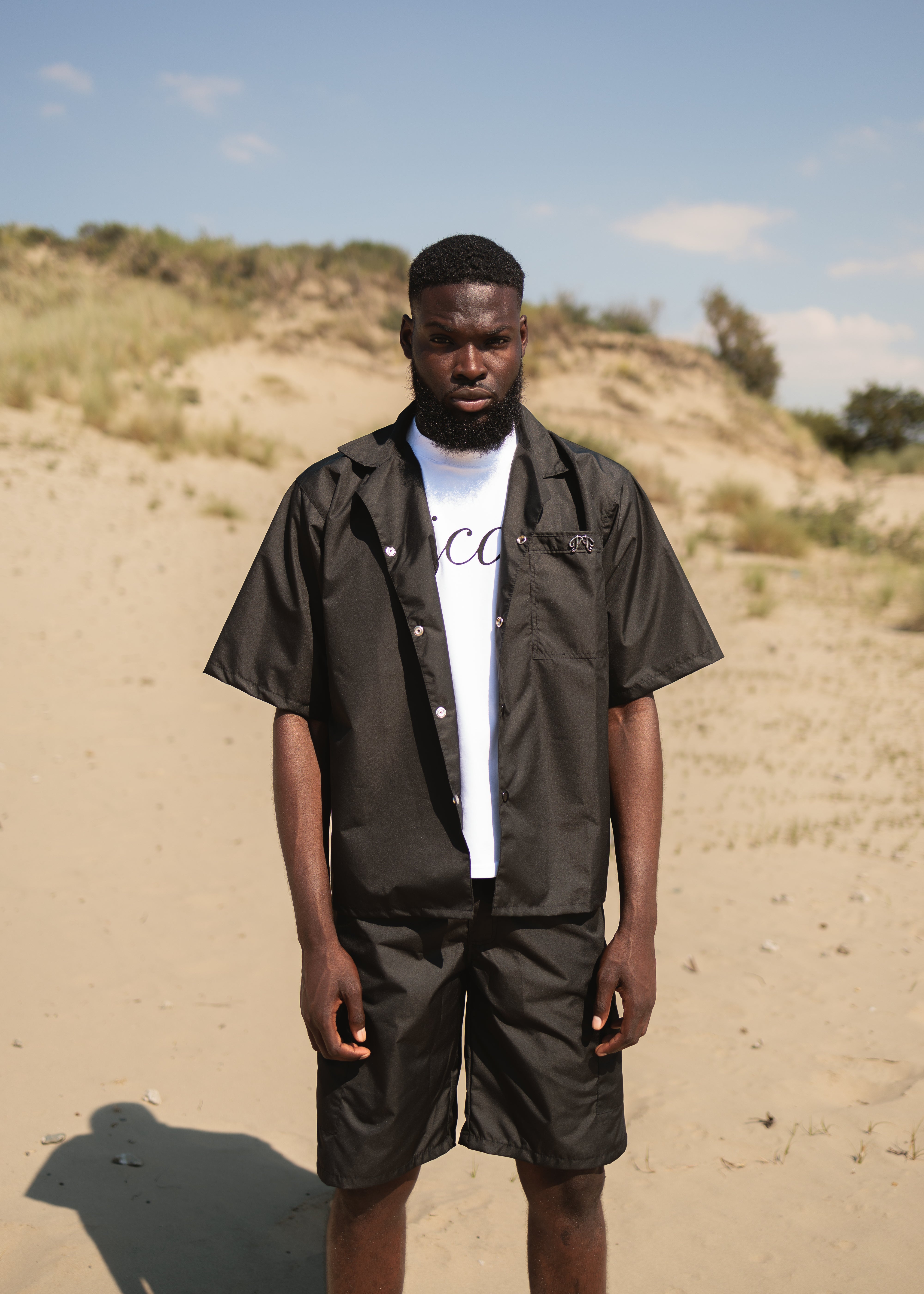 Picou Black Nylon Short offers a loose fit and feature two large side pockets and belt loops with a metal logo. The shorts come with a slightly pleated front and boast a trendy, casual design, making them perfect for a special occasion or relaxed wear.
