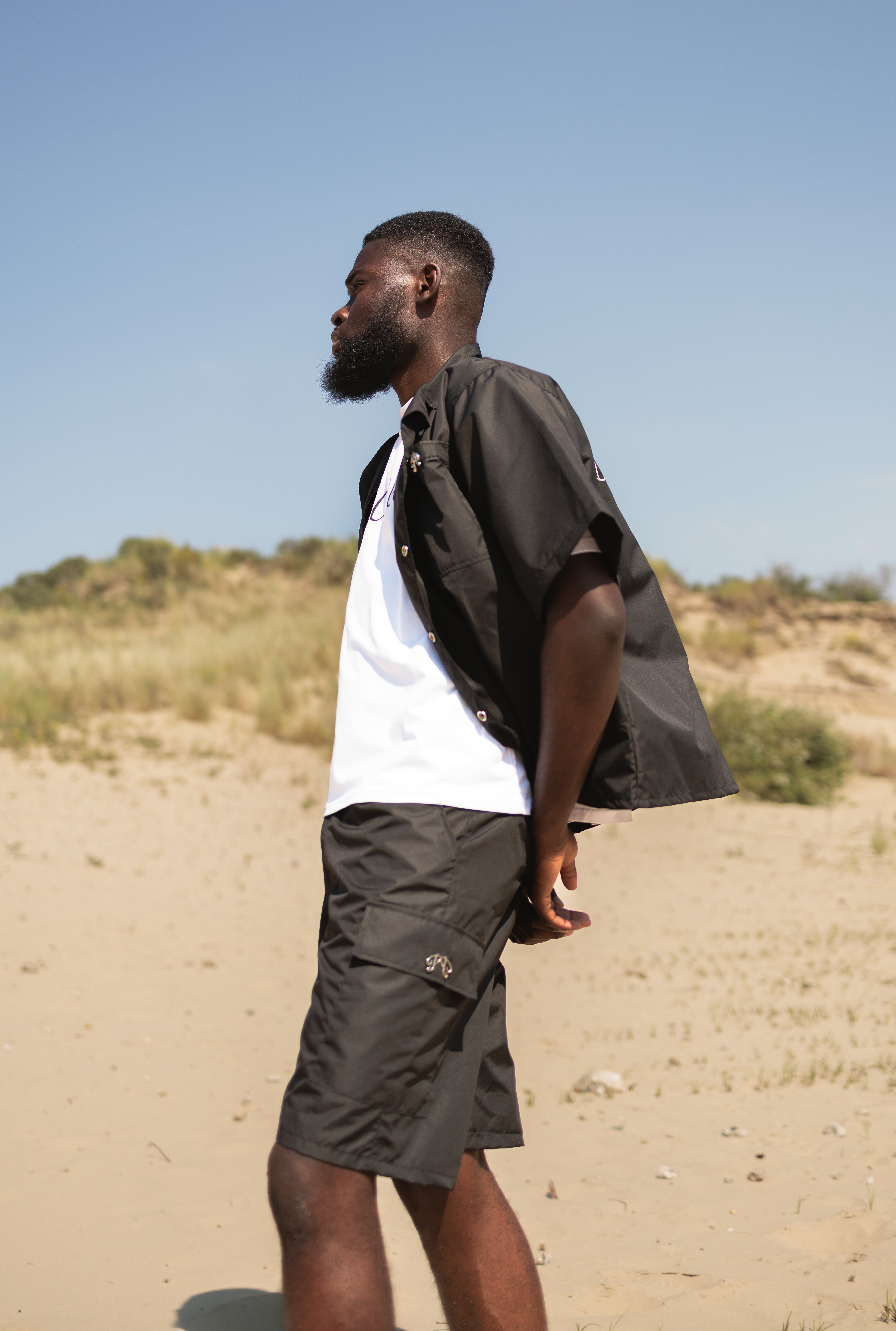 Picou Black Nylon Short offers a loose fit and feature two large side pockets and belt loops with a metal logo. The shorts come with a slightly pleated front and boast a trendy, casual design, making them perfect for a special occasion or relaxed wear.