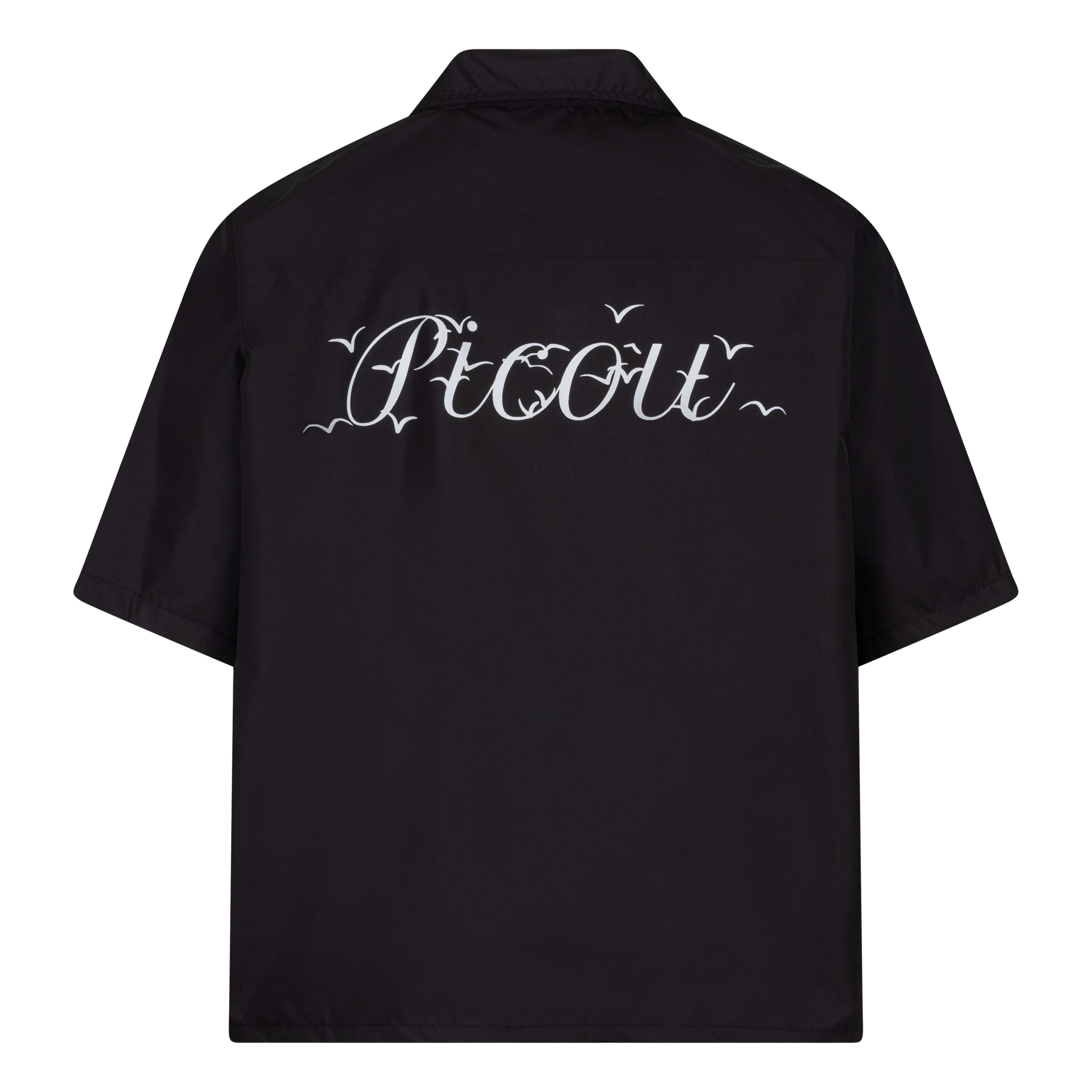 The Picou Nylon shirt in black is a short-sleeve button-up with a notched collar and a front pocket on the left chest. The pocket features a small metal tag design with intertwined letters in silver. This casual shirt offers a relaxed fit and is crafted from lightweight fabric, ideal for fashion-forward individuals seeking quality.