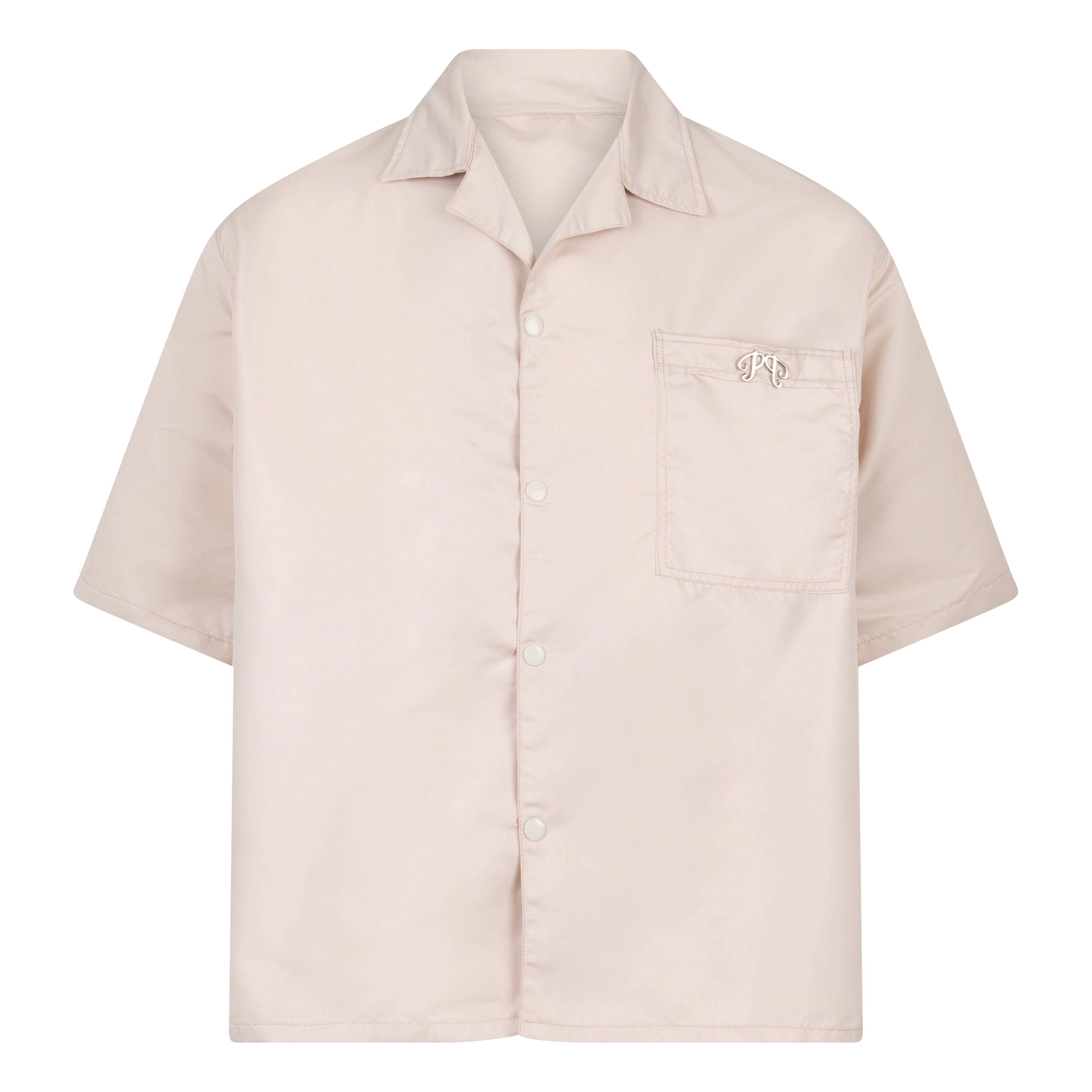 The Picou Nylon shirt in beige/cream is a short-sleeve button-up with a notched collar and a front pocket on the left chest. The pocket features a small metal tag design with intertwined letters in silver. This casual shirt offers a relaxed fit and is crafted from lightweight fabric, ideal for fashion-forward individuals seeking quality.